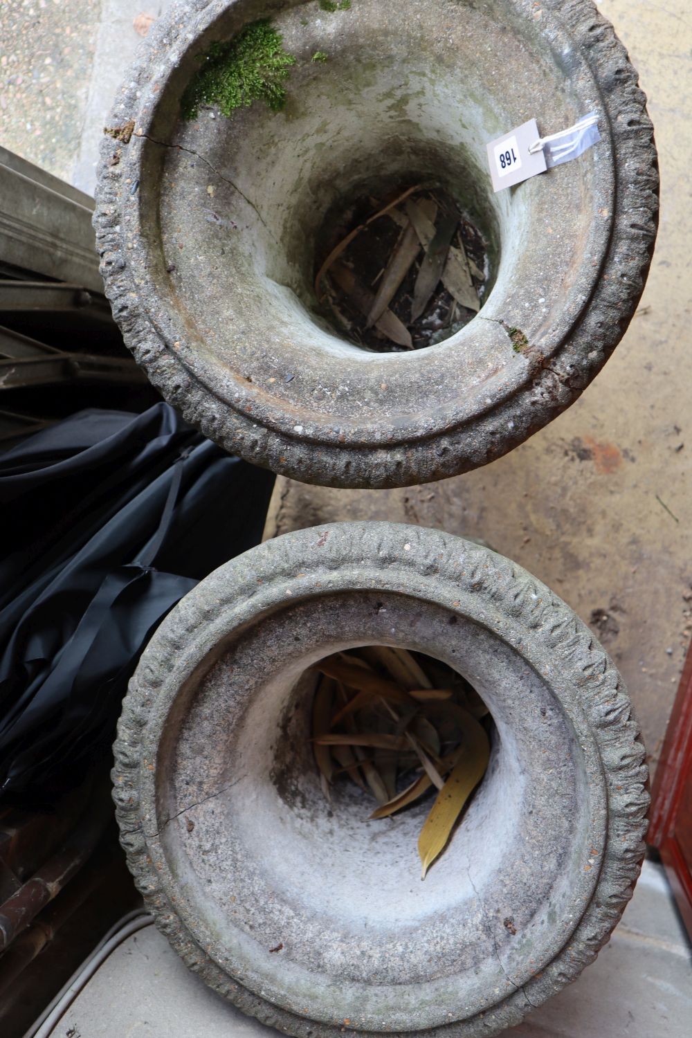 A pair of reconstituted stone garden urns, height 60cm